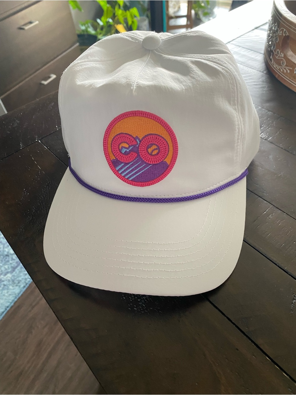 White Hat with Pink & Orange Circular Logo and Purple Trim